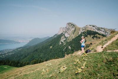 Man standing on mountain against sky