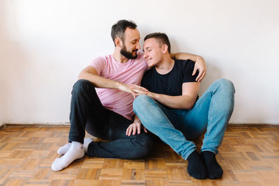 Gay couple hugging at home