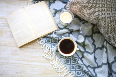 High angle view of coffee with milk and book on table