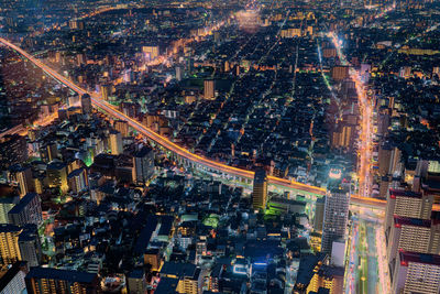 High angle view of city lit up at night