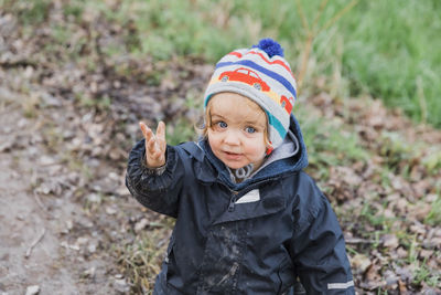 Portrait of girl gesturing while standing on land