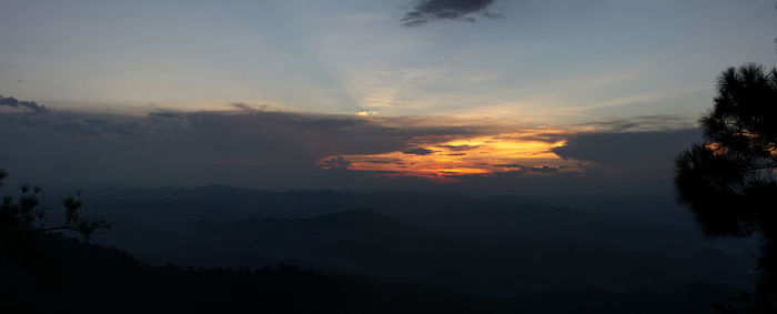 Scenic view of silhouette mountains against sky at sunset