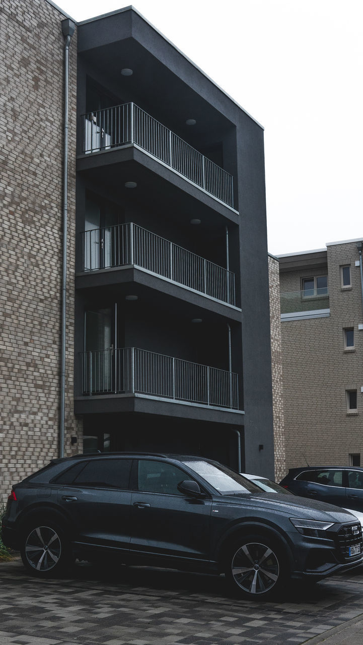 CAR ON STREET BY BUILDINGS