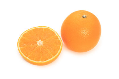 Close-up of orange slices over white background