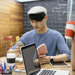 Man working on table at cafe