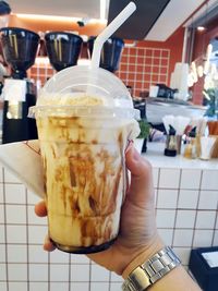 Close-up of hand holding ice cream