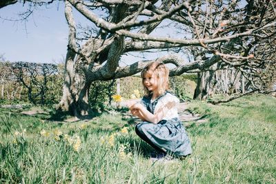 Girl picking flowers on in a field on a beautiful sunny day