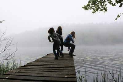 Rear view of people on mountain against sky