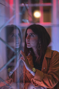 Reflection of young woman on glass