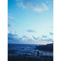 Scenic view of sea against cloudy sky