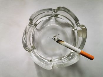 High angle view of cigarette against white background