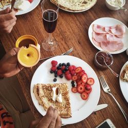 Cropped image of people having breakfast at table