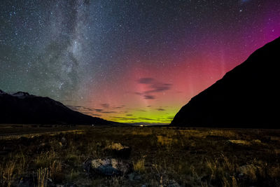 Scenic view of landscape against sky at night