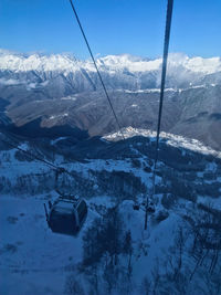 Gondola lift in ski resort in winter mountains. beautiful snow-covered forest, winter landscape.