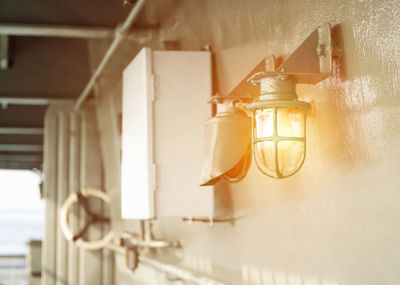 Low angle view of lamp hanging on wall