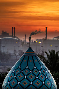 Close-up of buildings against sky at sunset