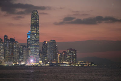 Illuminated buildings against sky at night