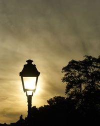 Low angle view of street light against sky during sunset