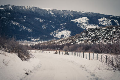 Scenic view of snow covered mountains against sky