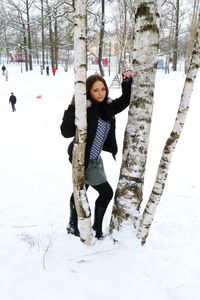 Portrait of young woman standing in snow