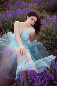 A beautiful young girl against the sunset and a beautiful sky in a lavender field. 