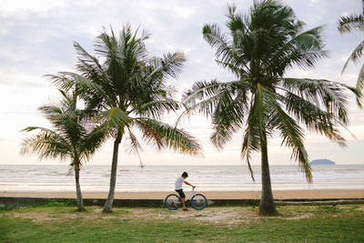 Boy riding bicycle at beach