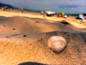 Close-up of sand on beach against sky