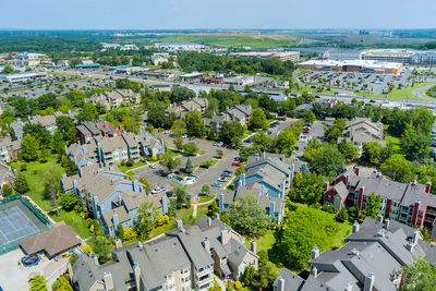 High angle view of townscape by sea against sky