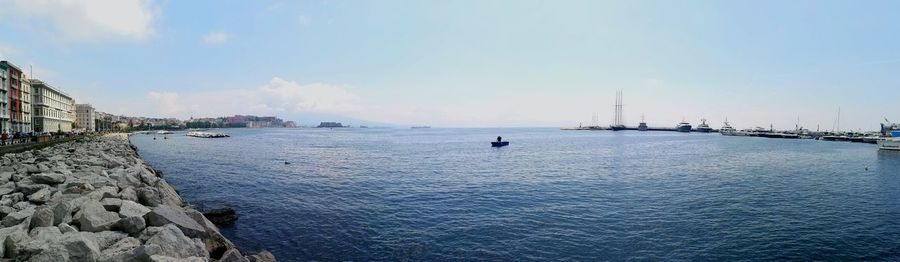 Panoramic view of sea and buildings against sky