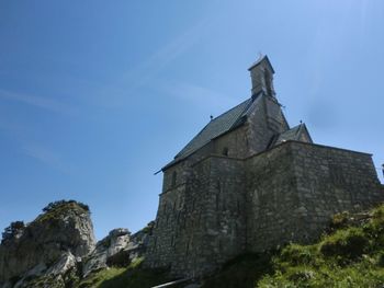 Low angle view of built structure against blue sky