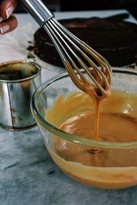 Cropped hand of woman mixing caramel