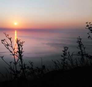 Scenic view of lake against sky during sunset