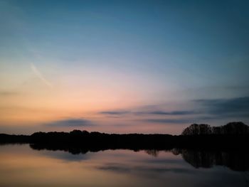 Scenic view of lake against sky during sunset