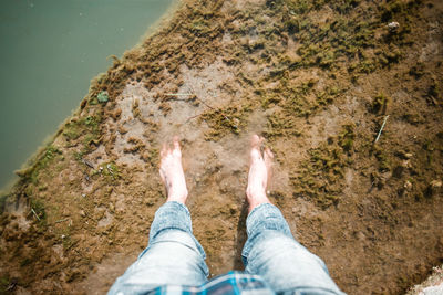 Low section of person legs by sea