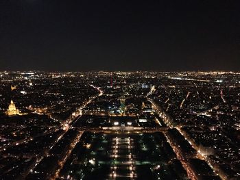 Illuminated cityscape against sky at night