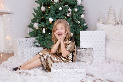 Portrait of young woman with christmas tree