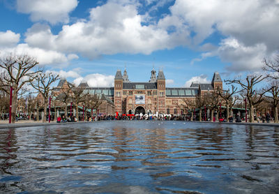 Reflecting pool and building against sky