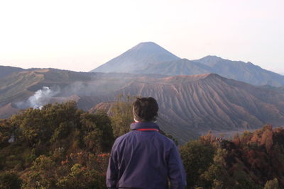 Rear view of man looking at mountains