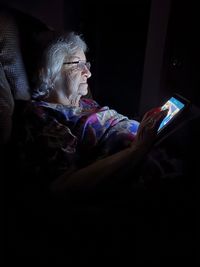 Cropped hand of woman sitting at home
