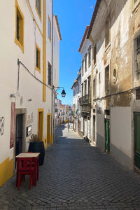 Empty alley amidst buildings in city