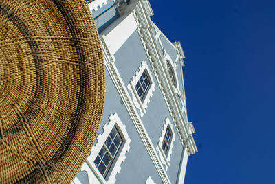 Low angle view of modern buildings against clear blue sky