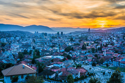 High angle shot of townscape against sky at sunset