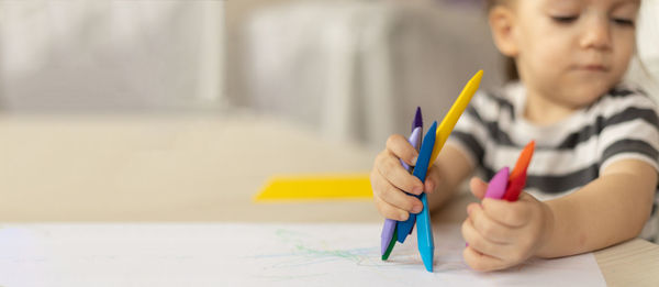 Midsection of woman drawing on table
