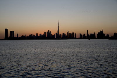 Dubai slyline from dubai creek harbour and dubai canal to downtown and business bay, uae