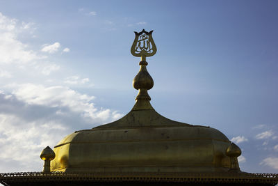 Low angle view of sculpture on building against sky