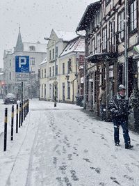 Street amidst buildings during winter