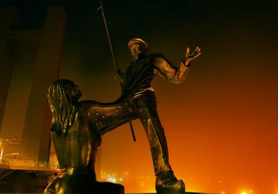 Low angle view of statue against sky at night