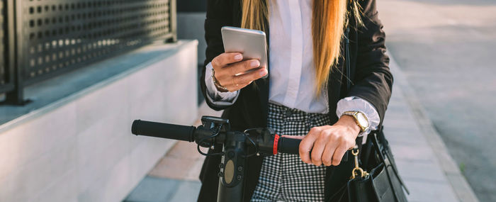 Midsection of man using mobile phone