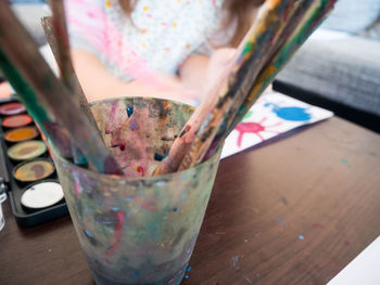 Close-up of paintbrushes in container on table