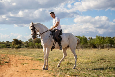 Horse riding horses on a field